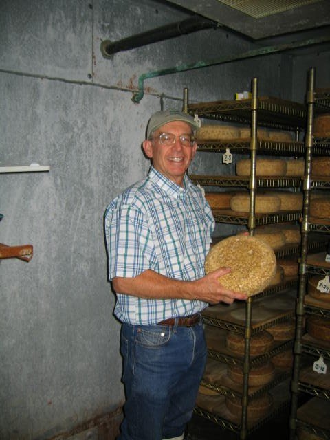 Mike Gingrich holding an early wheel of Pleasant Ridge Reserve in the aging room, 2000
