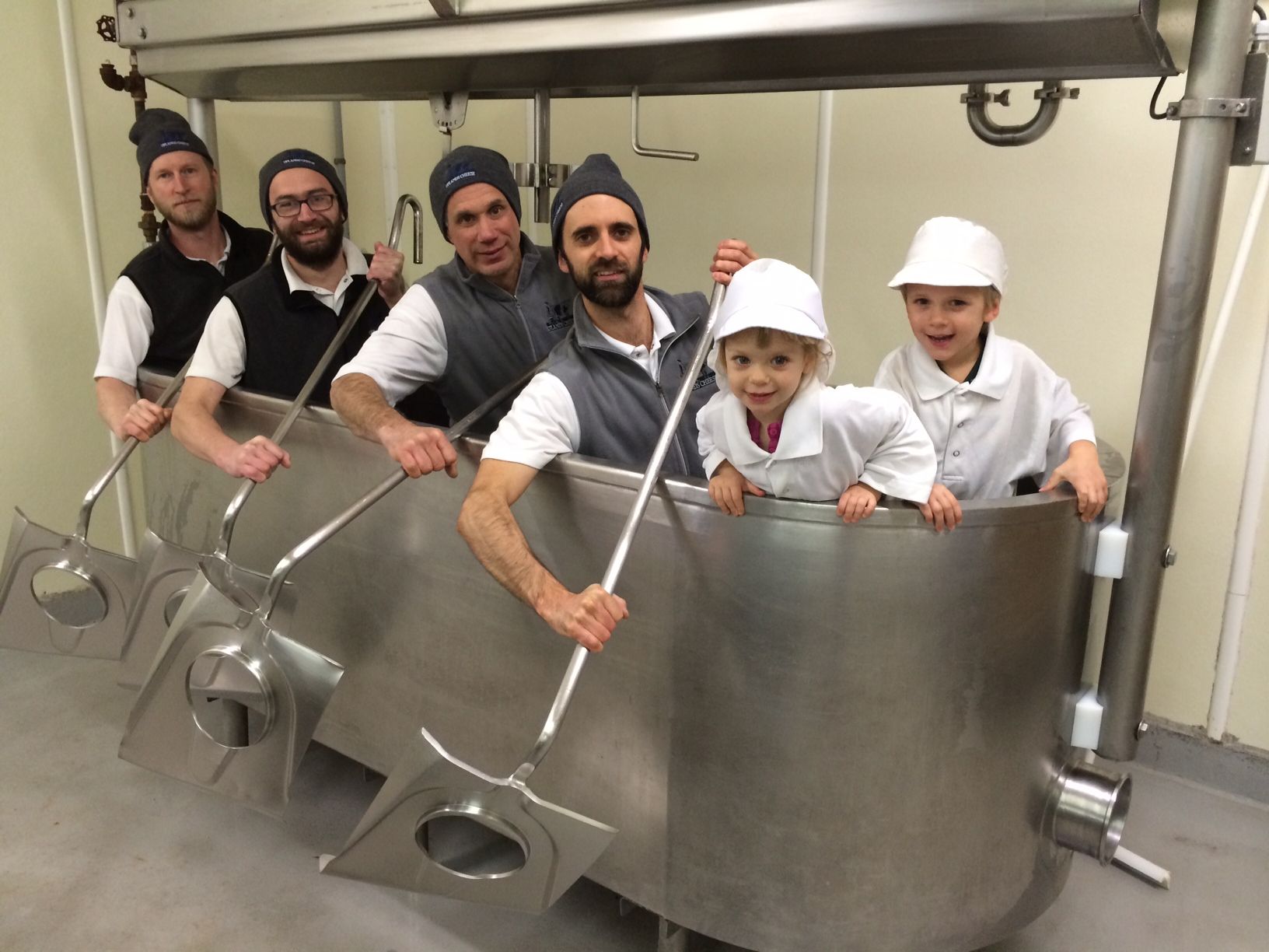 cheesemakers at Uplands Cheese sitting in an empty cheese vat