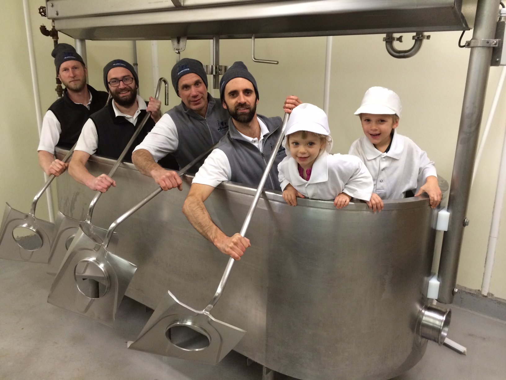 cheesemakers at Uplands Cheese sitting in an empty cheese vat
