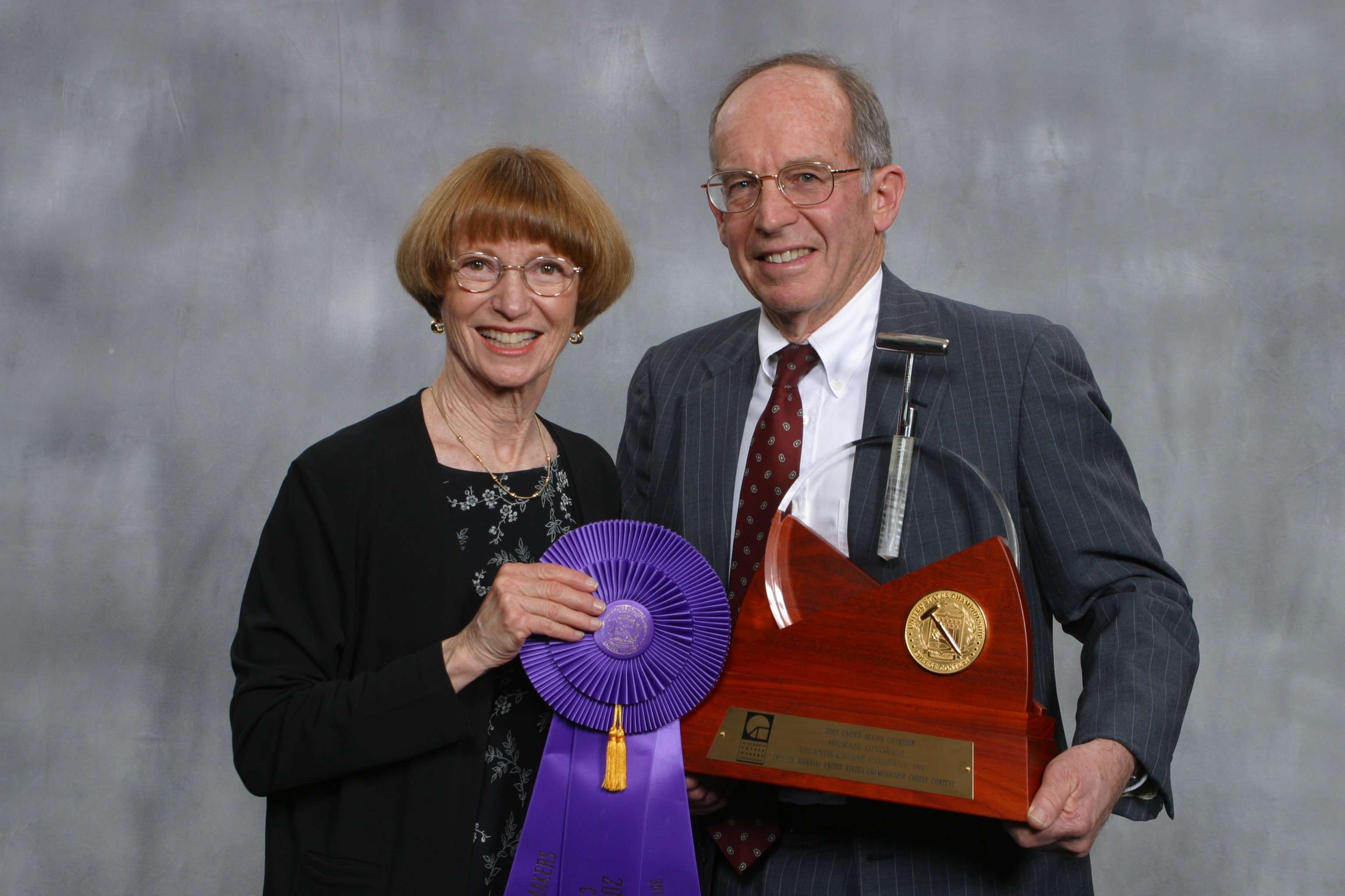 Mike and Carol Gingrich posing with the US Cheese Champion trophy