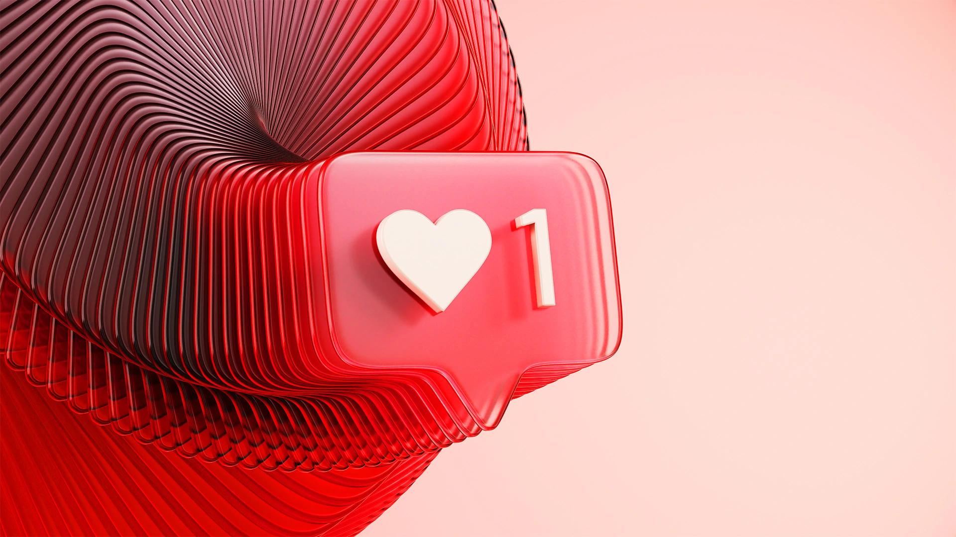 Red like notification bubble with a heart and '1' against abstract red and black swirls from Getty Images