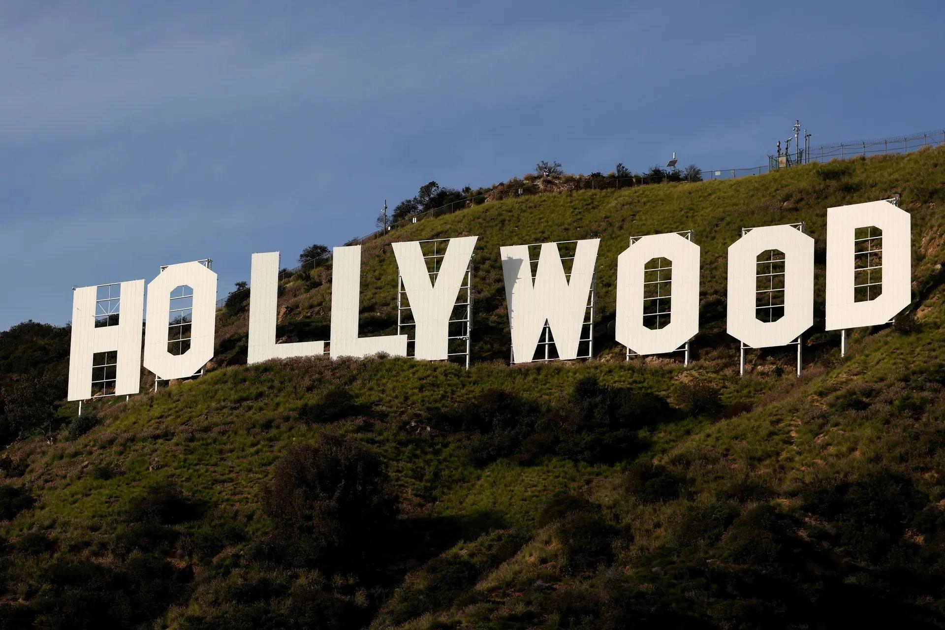 The large white Hollywood sign on a green hillside.