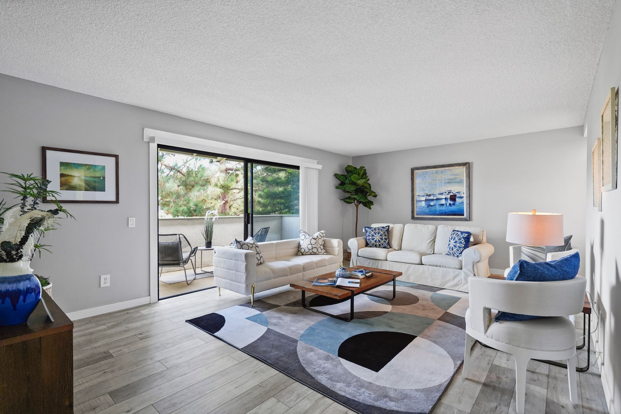 Great room of a condo, open to a modern kitchen