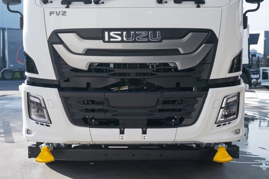 Front of a white Isuzu water truck cab