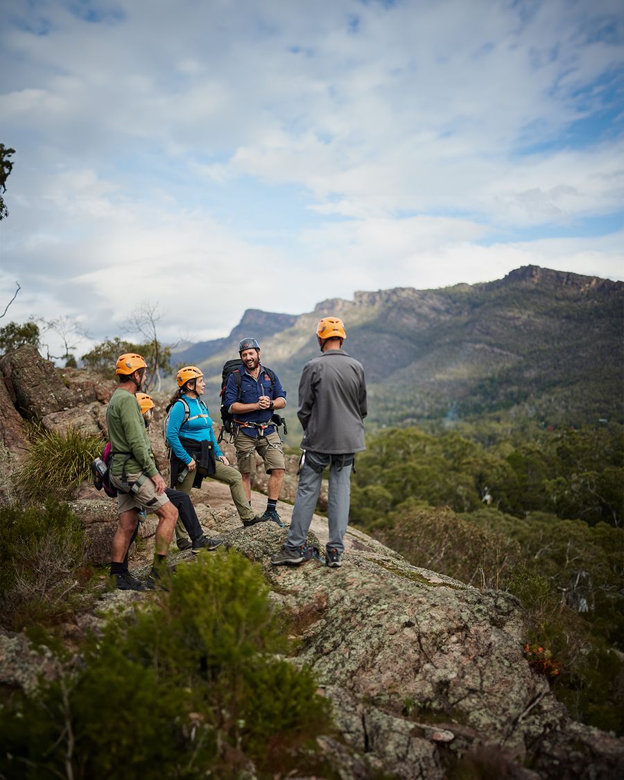Group in hi-vis helmets on a rocky outcrop