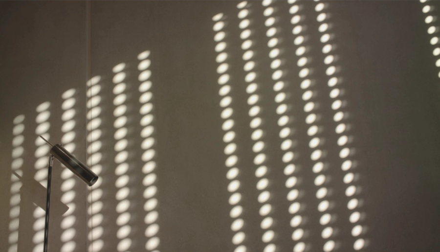 Light and shadow through a perforated panel