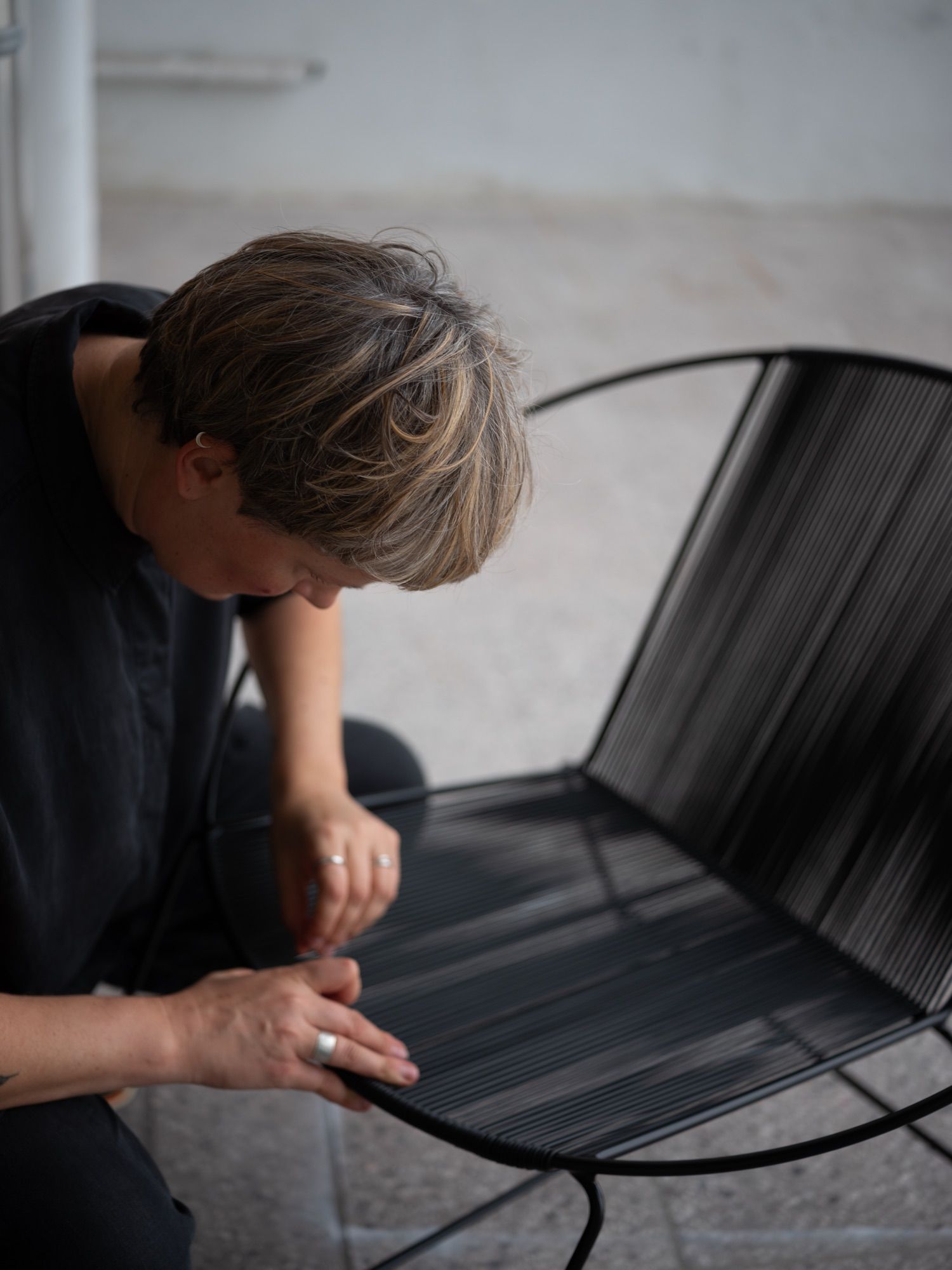Weaving the seat of a Circle chair by hand.