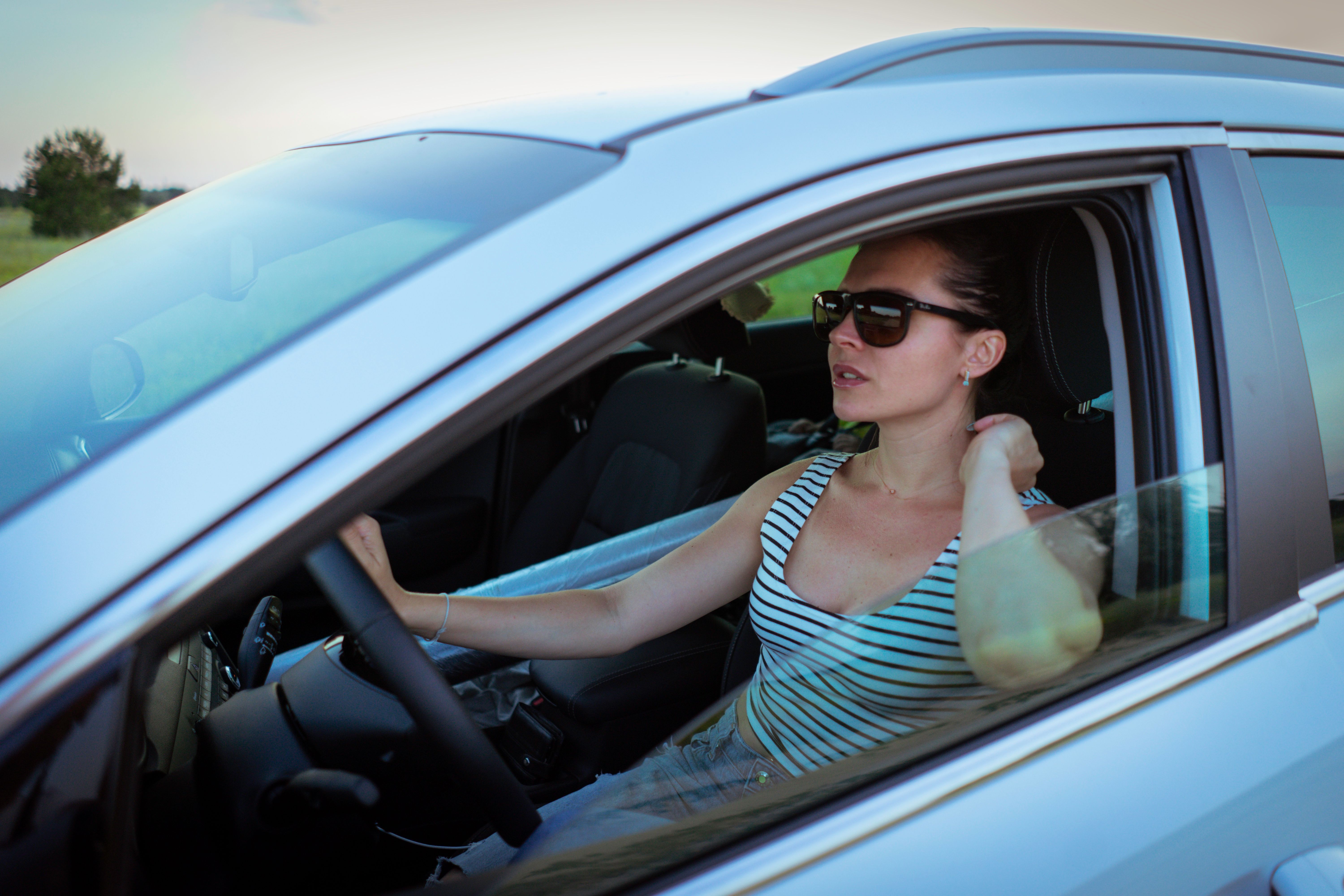 Woman driving on a rural New Jersey road, the kind of summer route where tourist driver car accidents happen