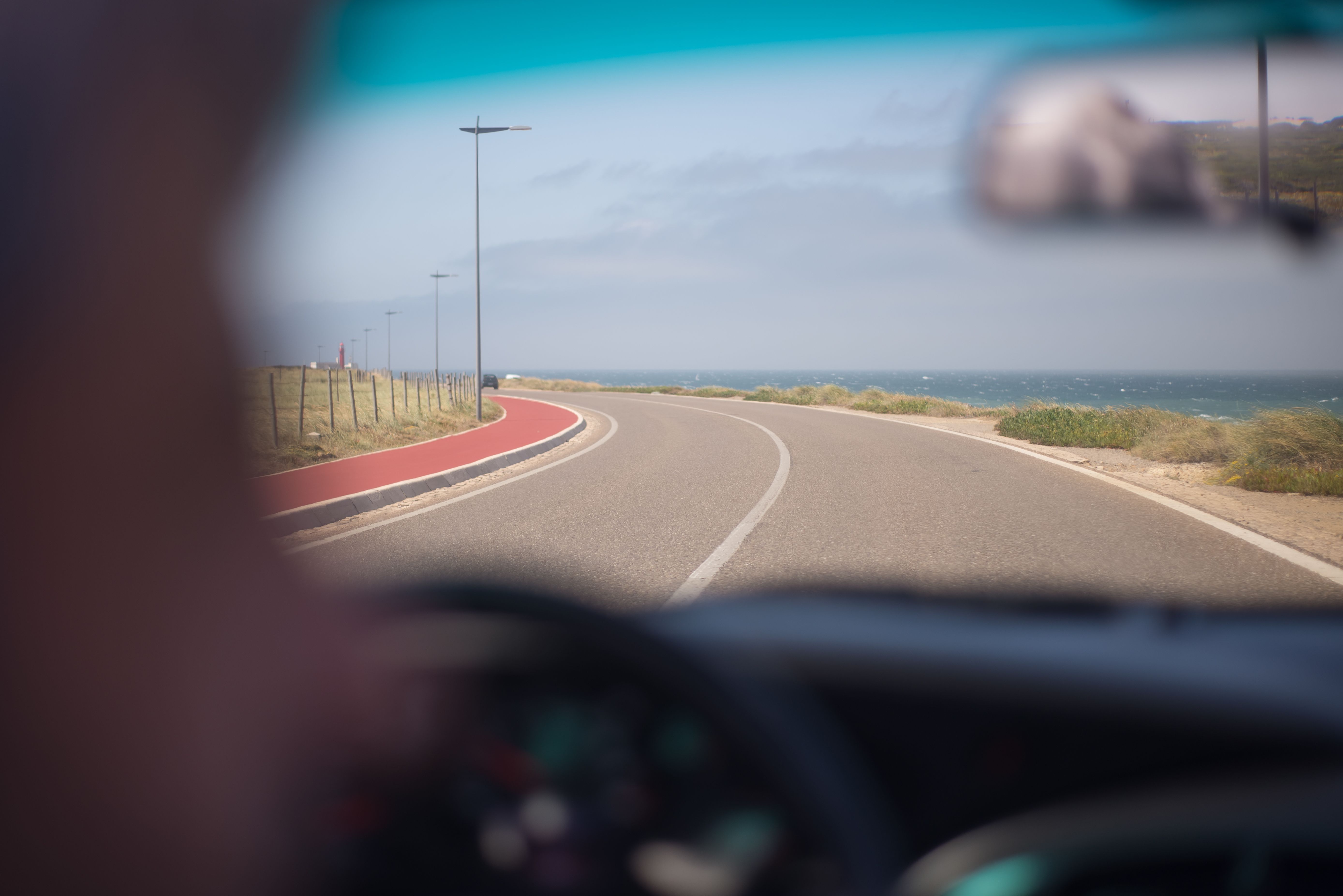 View through a windshield of a curving coastal highway, illustrating Atlantic City Expressway car accident risks during shore traffic season.