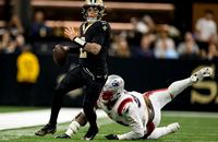 New Orleans Saints quarterback Spencer Rattler throws a pass against the New England Patriots.