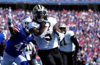 Saints running back Kendre Miller (5) runs for a touchdown past Buffalo Bills cornerback Christian Benford (47) during the first quarter of Sunday's game.
