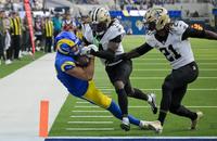Los Angeles Rams wide receiver Puka Nacua (12) scores a touchdown as New Orleans Saints cornerback Kool-Aid McKinstry (4) and safety Justin Reid (21) defend during the first half at SoFi Stadium.