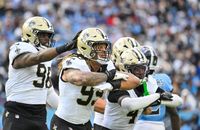 New Orleans Saints defensive ends Chase Young (99) and Carl Granderson (96) and cornerback Kool-Aid McKinstry (4) celebrate a sack in the second half of a game against the Tennessee Titans, Sunday, Dec. 28, 2025, in Nashville, Tenn.