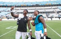 Jaguars running back Travis Etienne Jr. takes a selfie with his brother, Panthers running back Trevor Etienne