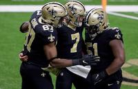 New Orleans Saints tight end Jared Cook (87), quarterback Taysom Hill (7) and guard Cesar Ruiz (51) celebrate a touchdown.