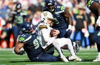 Seattle Seahawks defensive tackle Byron Murphy II (91) sacks New Orleans Saints quarterback Spencer Rattler (2) during the third quarter at Lumen Field