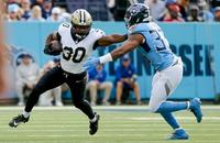 New Orleans Saints running back Audric Estime stiff arms Tennessee Titans linebacker Cedric Gray.