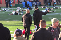 New Orleans Saints running backs coach Joel Thomas (left) and quarterbacks coach Scott Tolzien (right) talk during practice at the Panini Senior Bowl in Mobile, Ala.
