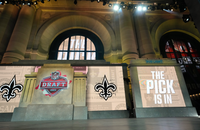 The onstage video screens display "The Pick Is In" for the New Orleans Saints during the 2023 NFL Draft, Thursday, April 27, 2023, in Kansas City