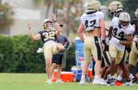 New Orleans Saints punter Kai Kroeger (32) punts during a training camp practice.