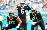 New Orleans Saints quarterback Tyler Shough makes adjustments before a play against the Miami Dolphins.
