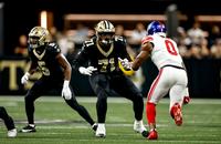 New Orleans Saints left tackle Kelvin Banks Jr. blocks New York Giants defender Brian Burns.
