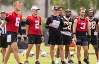 Saints quarterbacks Tyler Shough (6) and Spencer Rattler (2) look on during minicamp practice.