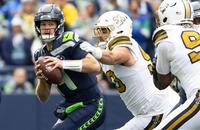 Seattle Seahawks quarterback Sam Darnold (14) is pressured by New Orleans Saints defensive tackle Bryan Bresee (90).