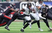 Jacksonville Jaguars running back Travis Etienne Jr. (1) runs with the ball against the Houston Texans.
