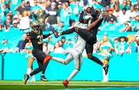 New Orleans Saints cornerback Kool-Aid McKinstry (4) intercepts a pass in front of Miami Dolphins wide receiver Jaylen Waddle (17) during the first half Sunday at Hard Rock Stadium in Miami Gardens, Fla.
