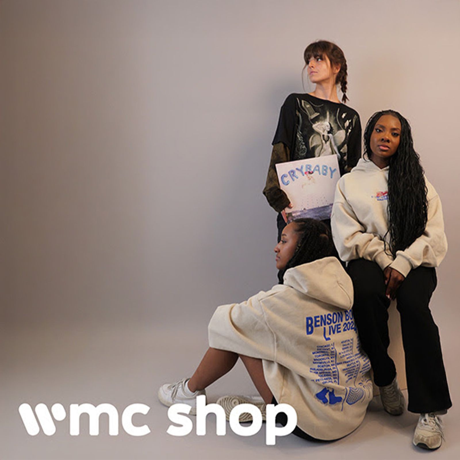 Three models wearing artist merchandise in a wmc shop lifestyle shoot