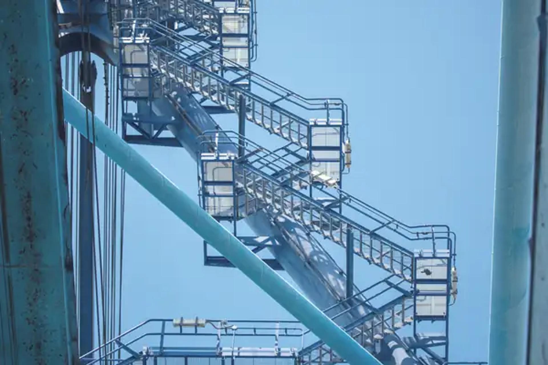 The stairway to a container crane cab at the Port of Mombasa against a blue sky