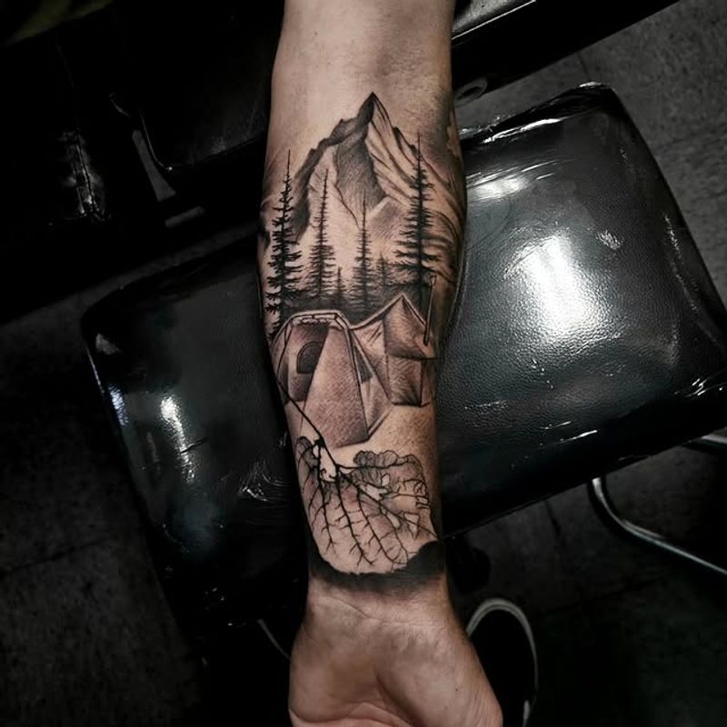 Black and grey forest landscape forearm tattoo by Sergio