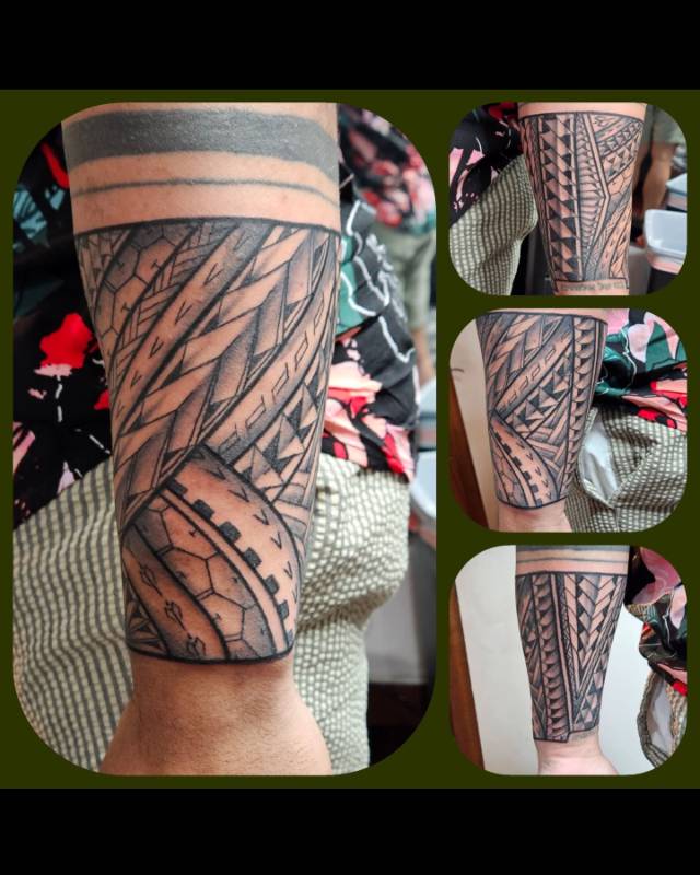 Tribal tattoo with geometric patterns on the forearm.