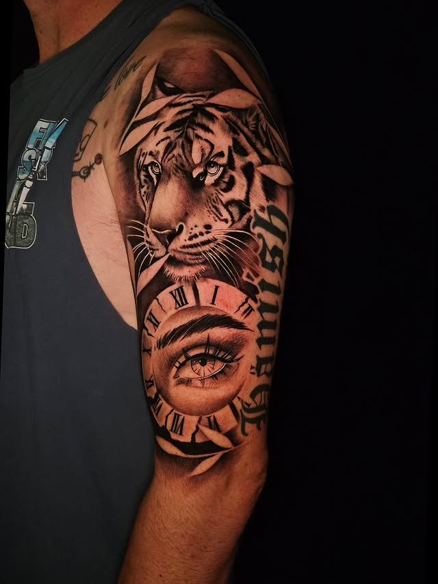 Black and grey tiger and eye realism upper arm tattoo by Sergio