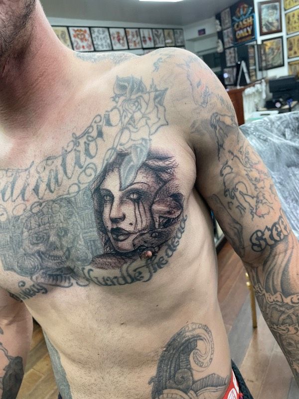 Tattoo of a woman's portrait on a man's chest