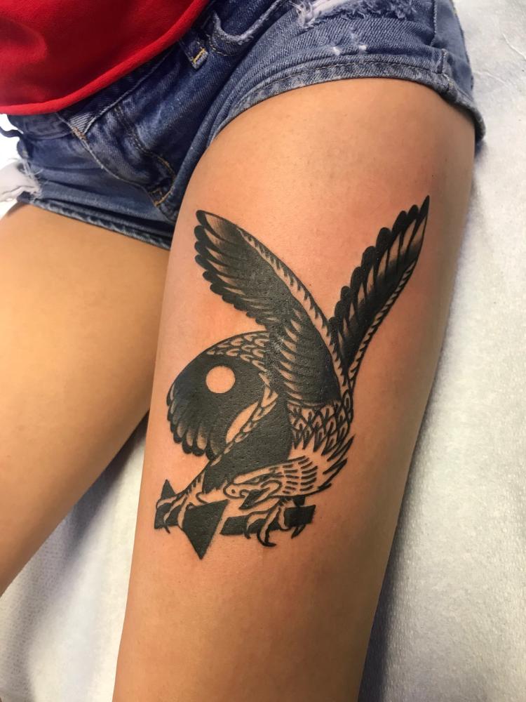 Black eagle tattoo in American Traditional style on thigh.