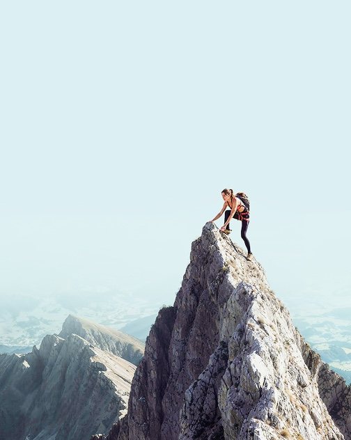 Woman climbing mountain