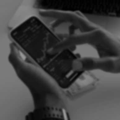 Person holding phone with trading app on screen