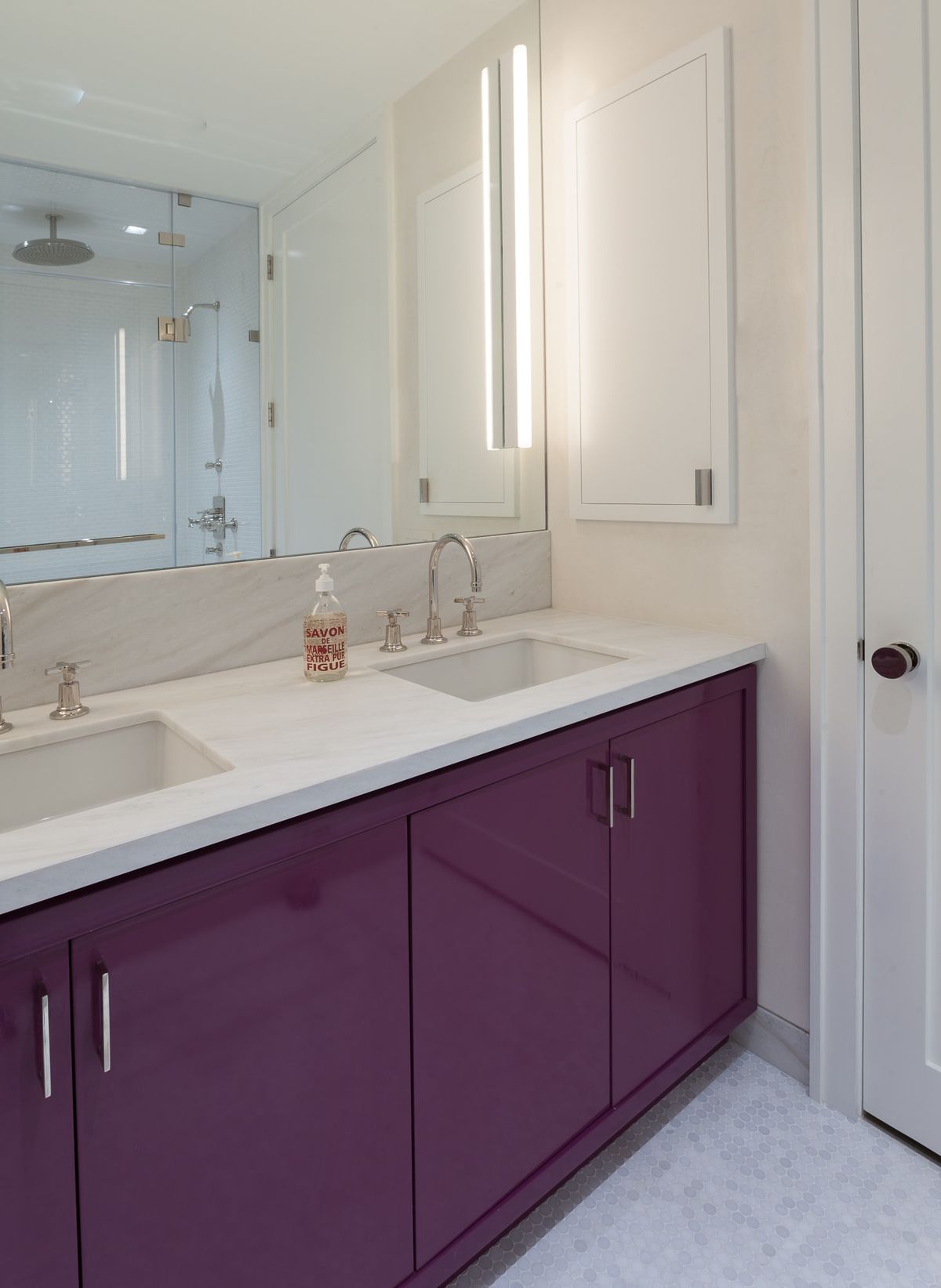 Bathroom with double sinks, large vanity mirror, hex-tile flooring and mulberry colored cabinets