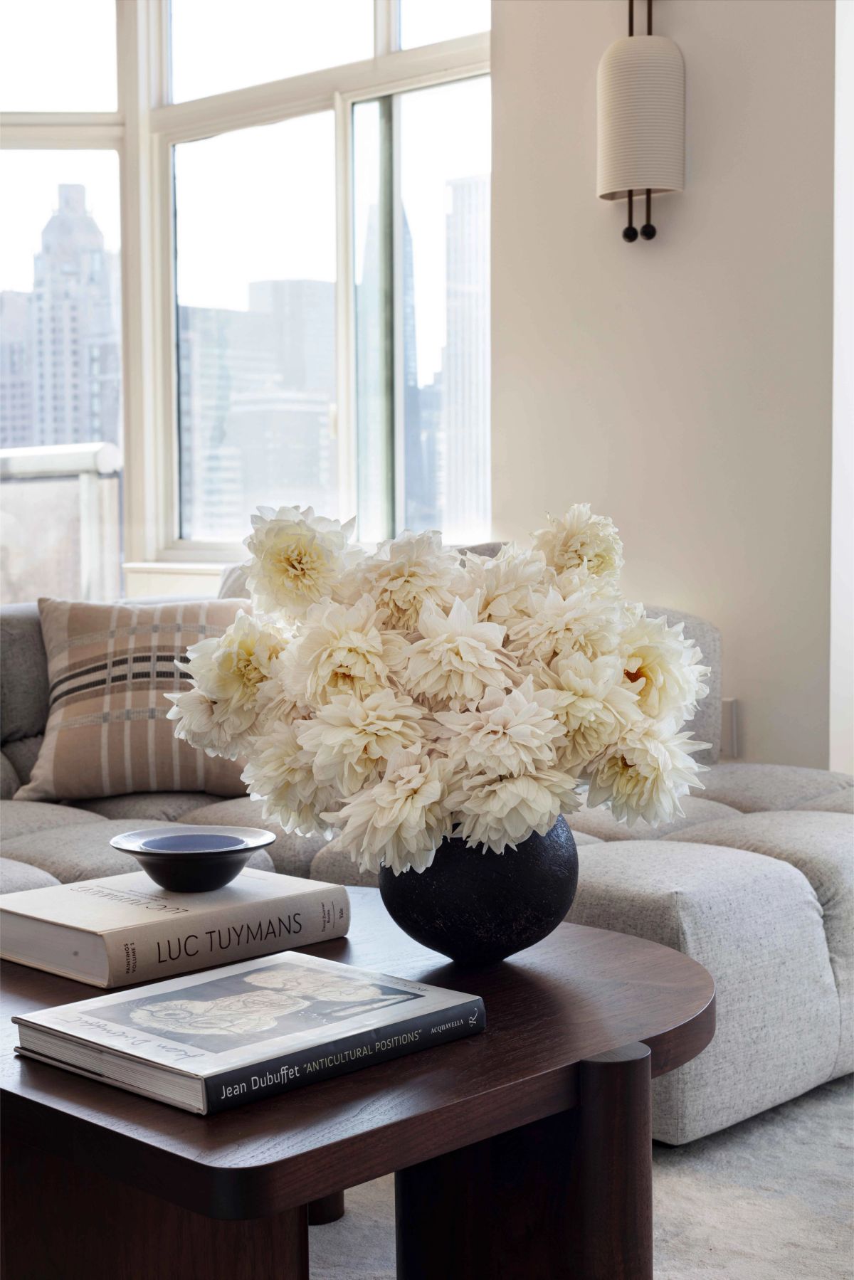 Detail of sofa and white flowers on coffee table