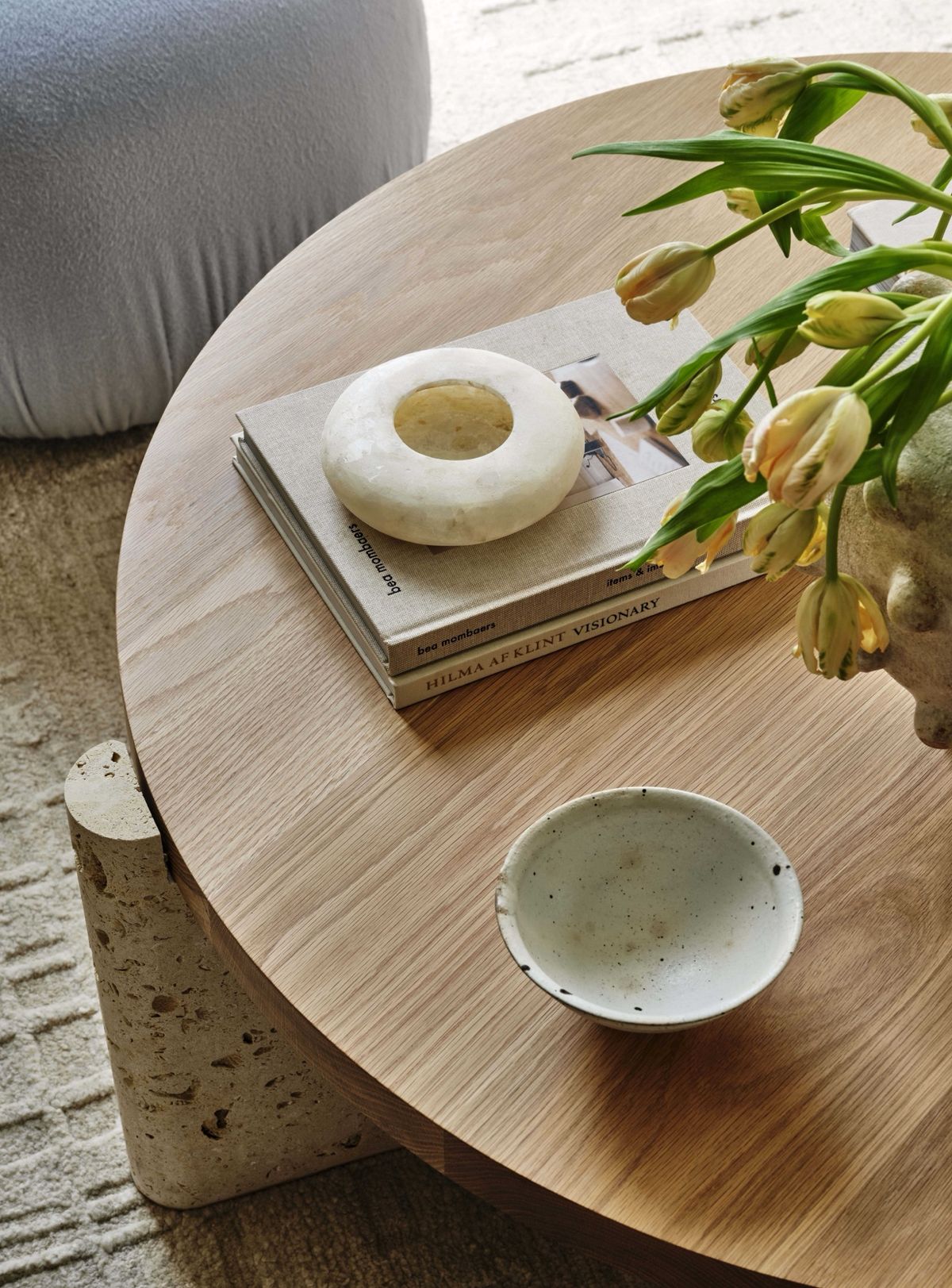 Vignette of table with books, ceramics and tulips