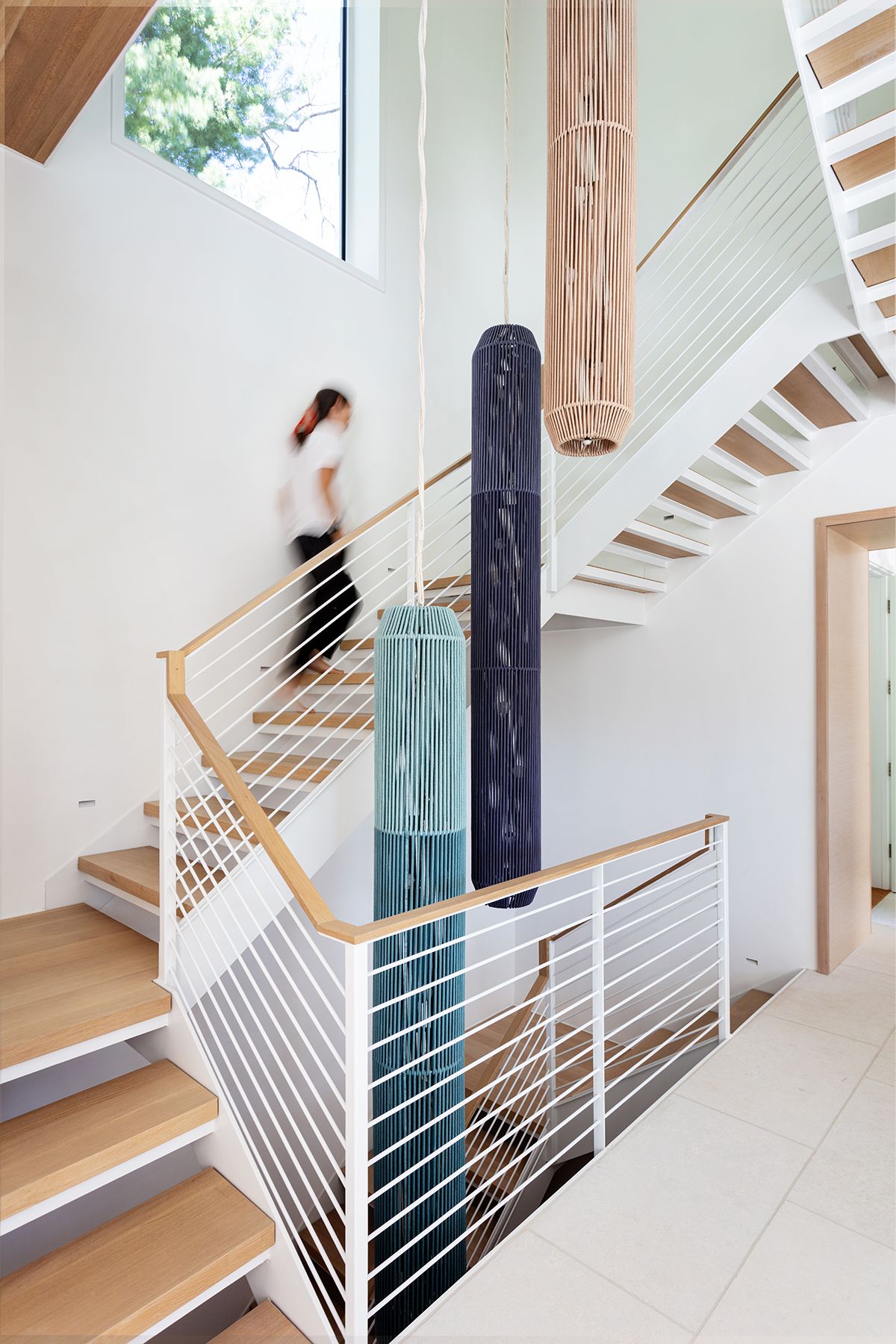 Stairwell with large pendant lamps hanging into the well