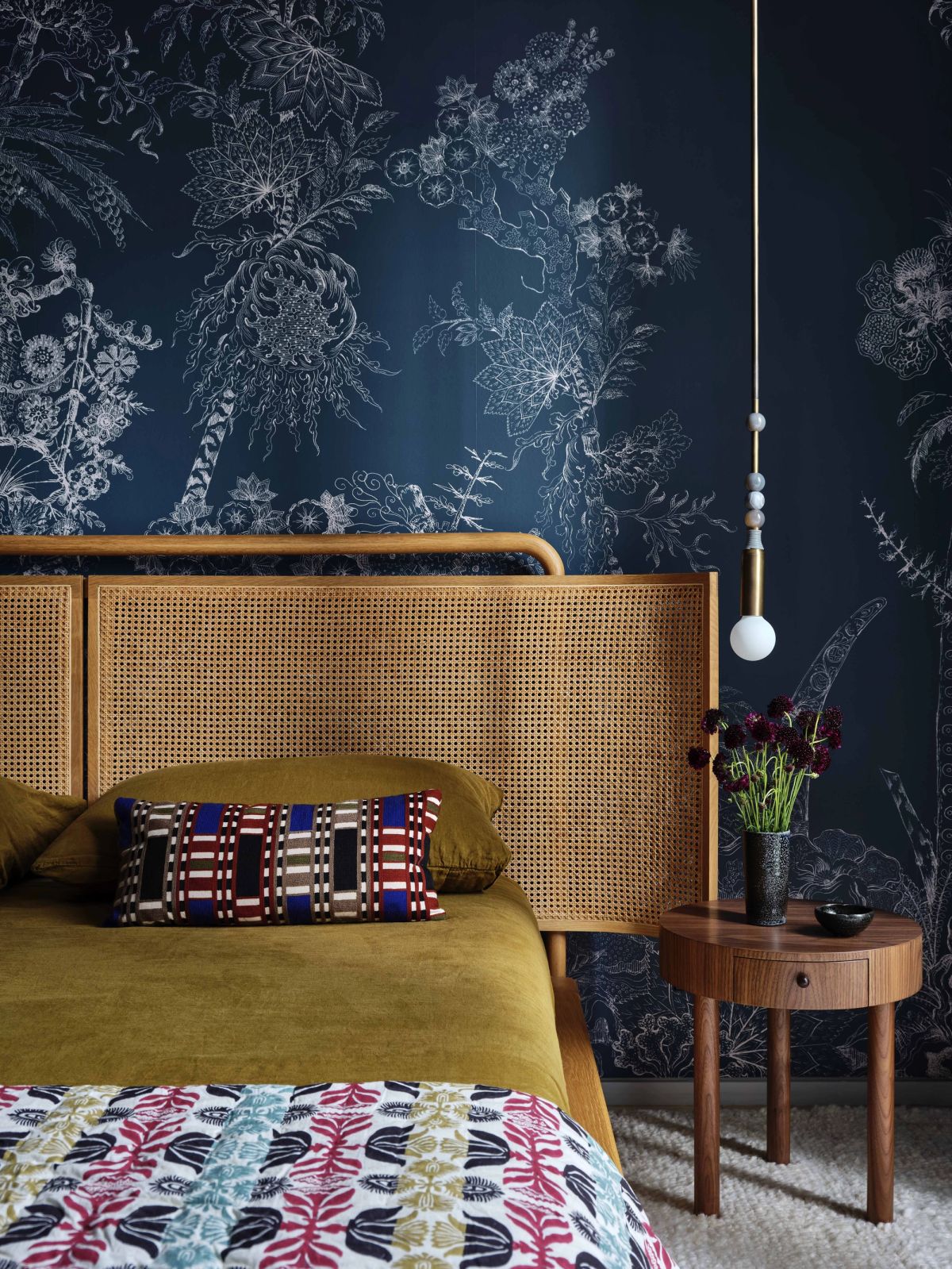 Detail of bed, bedside table, and wallcovering