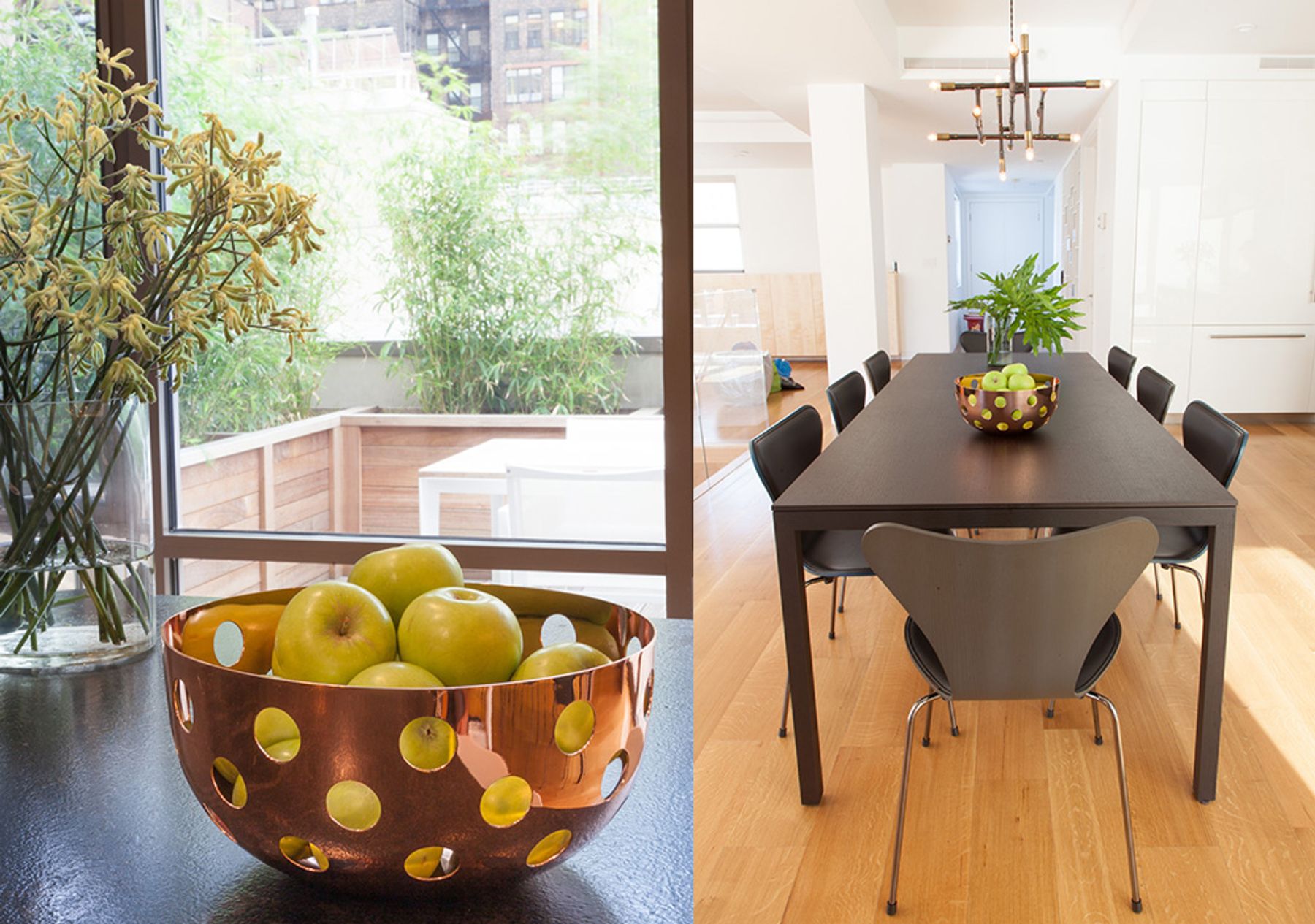 Detail of bowl of fruit on left; view of black dining table with bowl of fruit