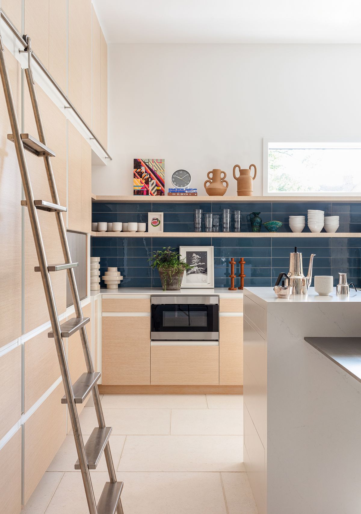 Kitchen with shelves and countertop and ladder to reach high spots