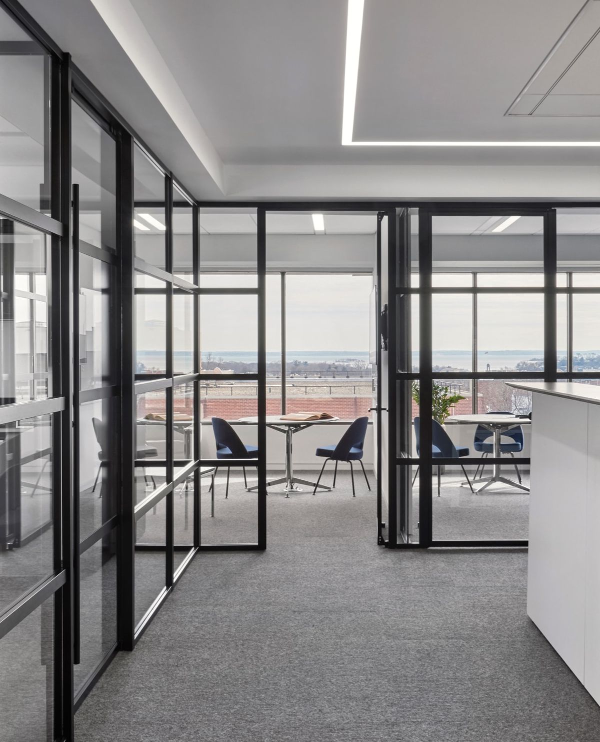 Closed offices with glass walls that lets natural light stream in