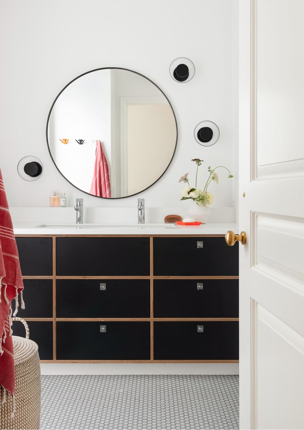 White bathroom with black storage drawers