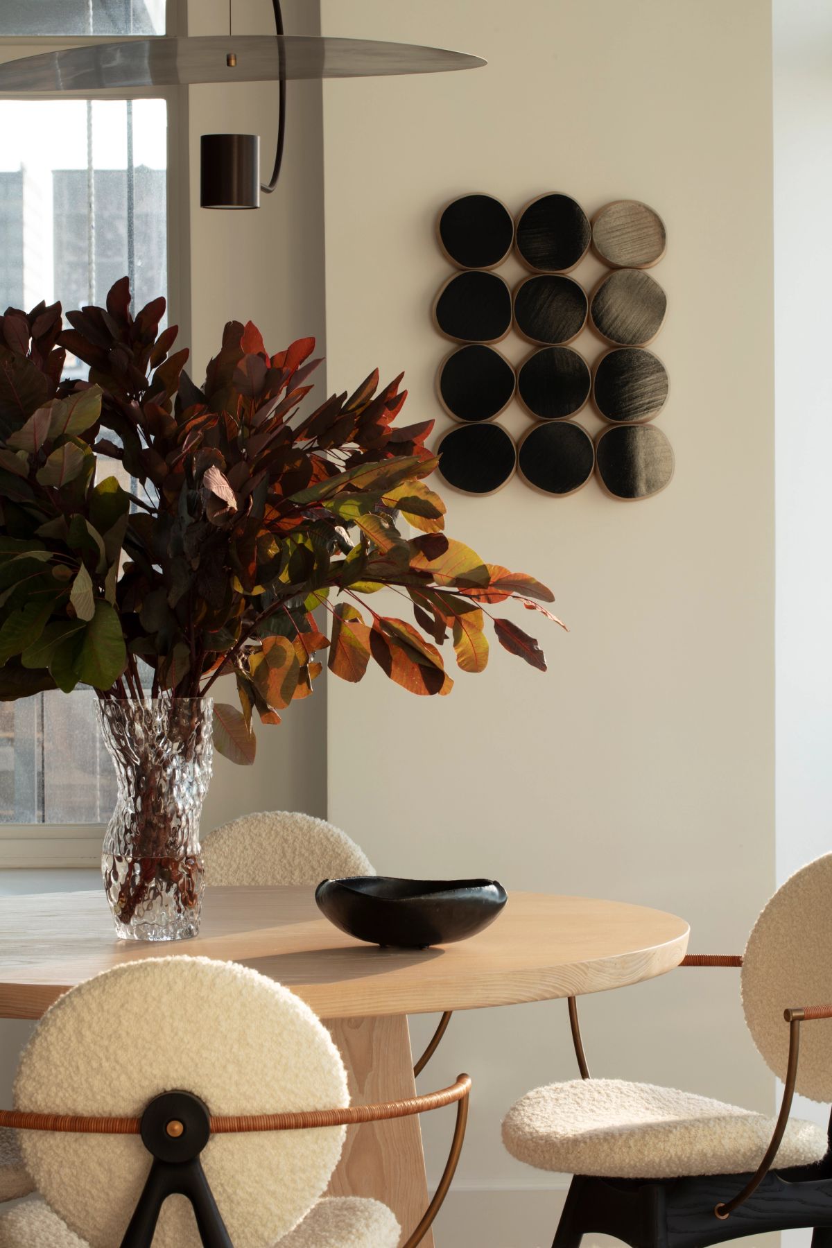 Detail of dining table and art on wall