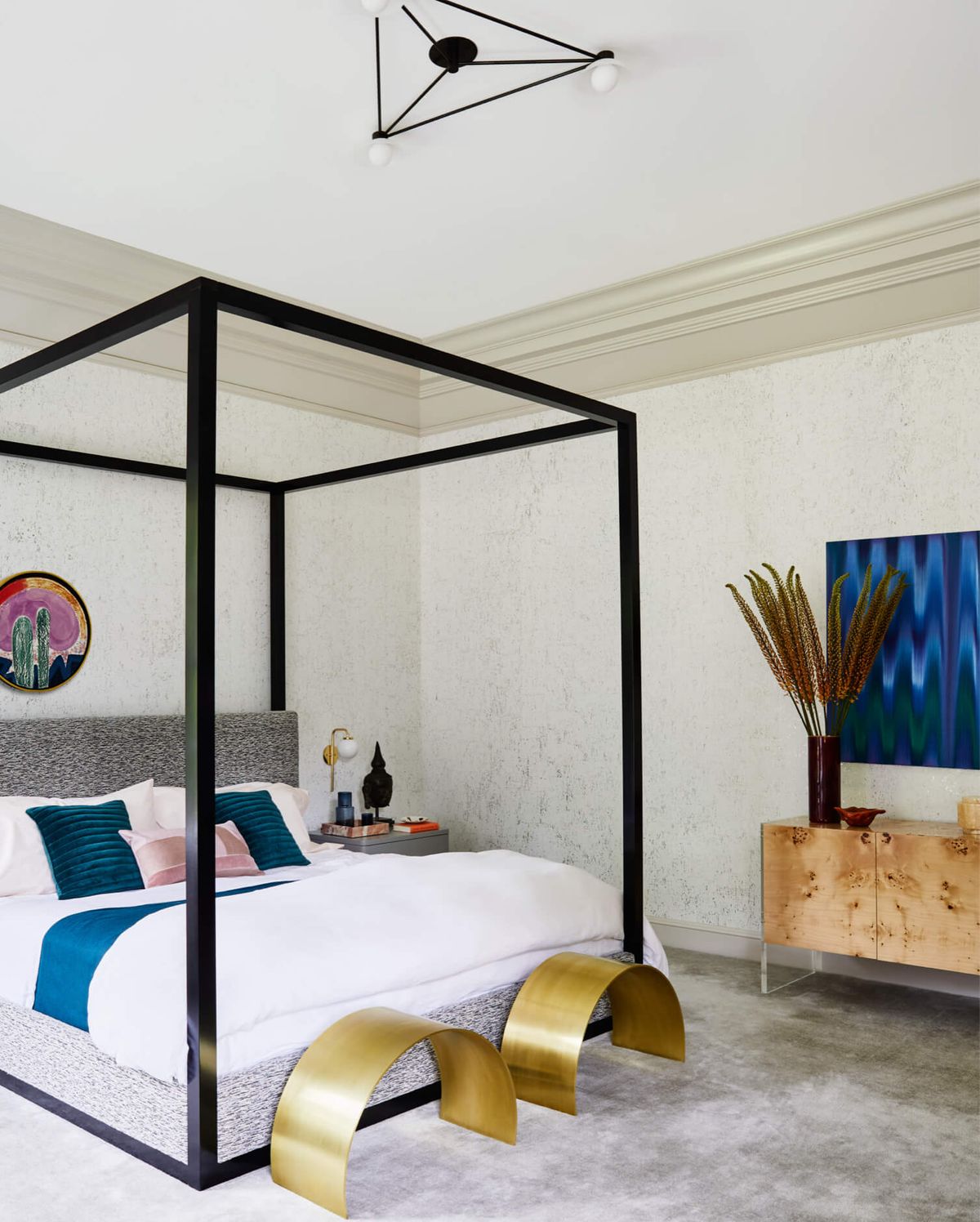 Primary bedroom with 4-poster canopy bed and bronze benches and the foot of the bed
